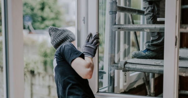 Two Men Installing Window On Wichita Home